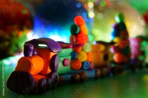 A toy train with plasticine gifts. Christmas background. New Year's holiday.