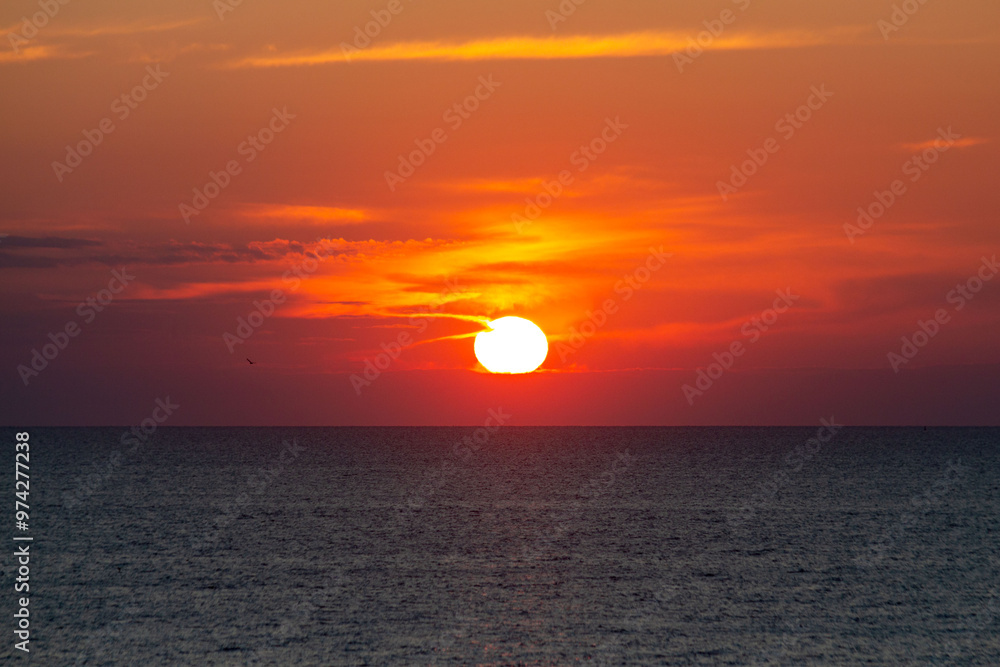 Landscape with sunrise over the sea with red clouds Landscape with sunrise over the sea with red clouds