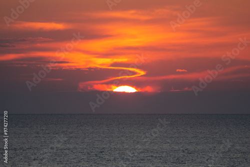Landscape with sun, sea and red clouds 