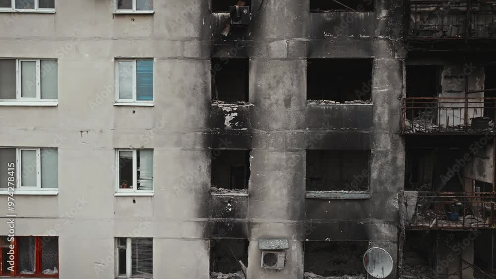 War in residential areas, broken windows and burned apartments. War in the city. City in war zone. Damage to a house as a result of artillery shelling. Armed conflict in Ukraine. High quality 4k War in residential areas, broken windows and burned apartments. War in the city. City in war zone. Damage to a house as a result of artillery shelling. Armed conflict in Ukraine. High quality 4k