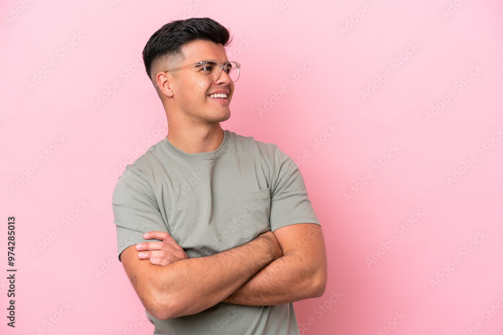 Obraz premium Young caucasian handsome man isolated on pink background happy and smiling