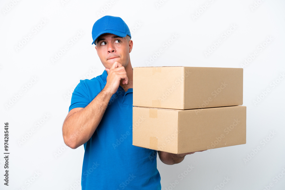 Delivery caucasian man isolated on white background having doubts and thinking Delivery caucasian man isolated on white background having doubts and thinking