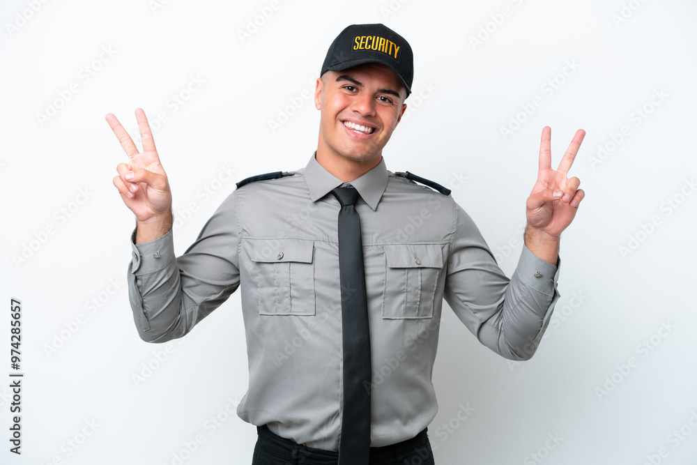 Young caucasian security man isolated on white background showing victory sign with both hands Young caucasian security man isolated on white background showing victory sign with both hands