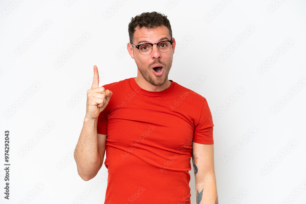 Young caucasian handsome man isolated on white background intending to realizes the solution while lifting a finger up Young caucasian handsome man isolated on white background intending to realizes the solution while lifting a finger up