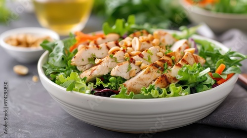 A salad with grilled chicken and a creamy peanut dressing.