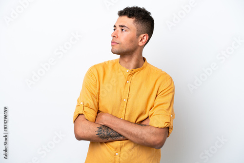 Young caucasian Brazilian man isolated on white background looking to the side