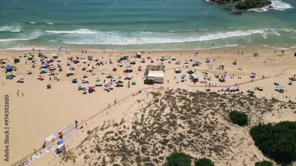 Aerial reveal dolly in Chia, Sardinia, Italy in front of Su Giudeu Island with view of Su Giudeu Beach and the Dunes. Beautiful seascape and crowded beach. 4K Drone Video. Aerial Shot.