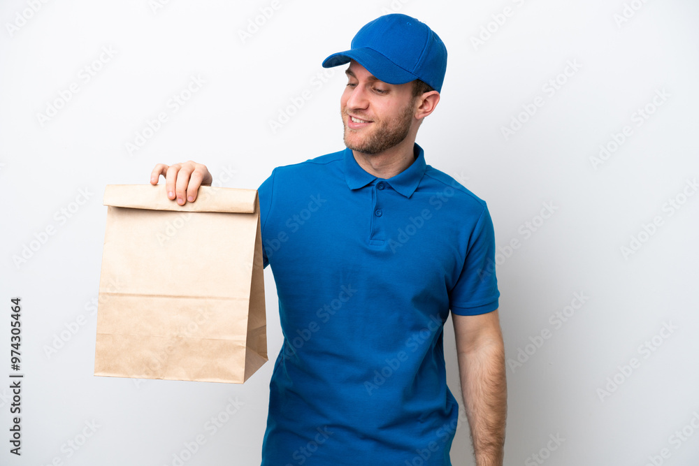 Delivery caucasian man isolated on white background looking to the side and smiling Delivery caucasian man isolated on white background looking to the side and smiling