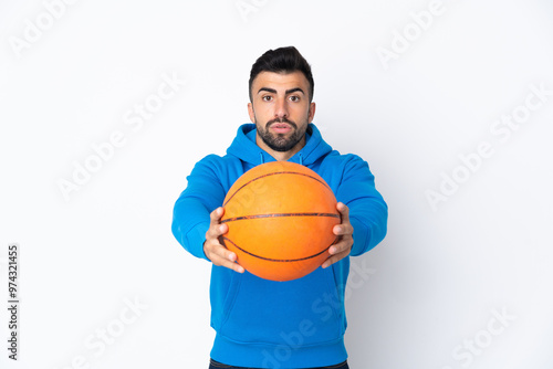 Caucasian man over isolated white background playing basketball