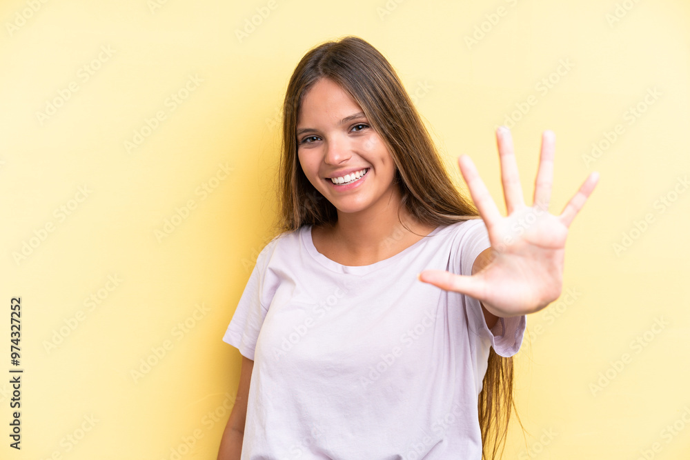 Young caucasian woman isolated on yellow background counting five with fingers Young caucasian woman isolated on yellow background counting five with fingers