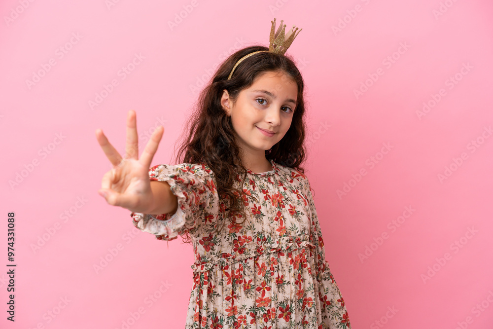 Little caucasian princess with crown isolated on pink background happy and counting three with fingers Little caucasian princess with crown isolated on pink background happy and counting three with fingers