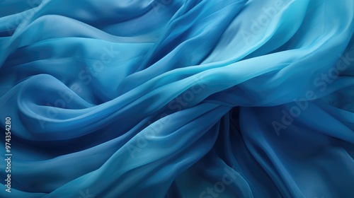 A soft, flowing blue fabric creates a beautiful abstract background. The gentle curves and folds of the material add a sense of movement and elegance.