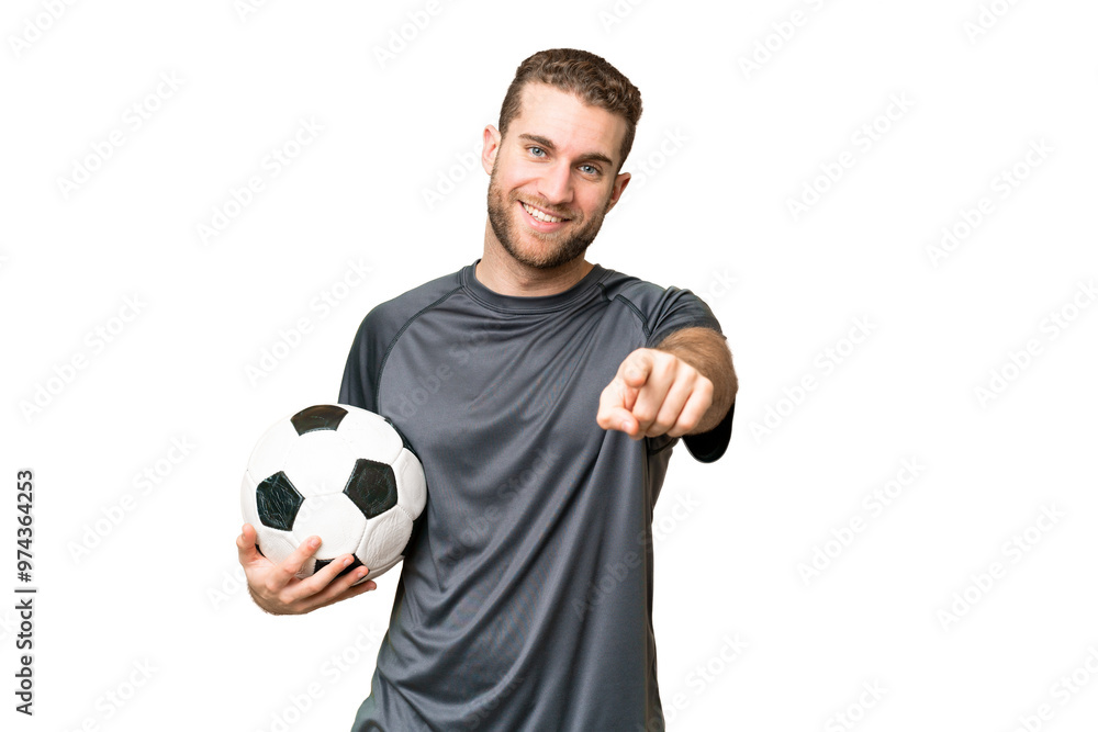 Young handsome blonde man over isolated chroma key background with soccer ball and pointing to the front Young handsome blonde man over isolated chroma key background with soccer ball and pointing to the front