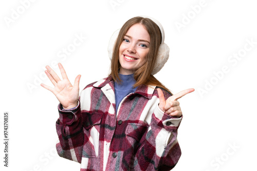 Young pretty woman wearing winter muffs over isolated chroma key background counting seven with fingers photo