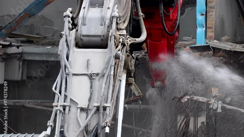 Close up of claw demolishing concrete with rebar