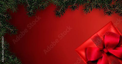 Rotes Geschenk mit Schleife vor Rotem Hintergrund