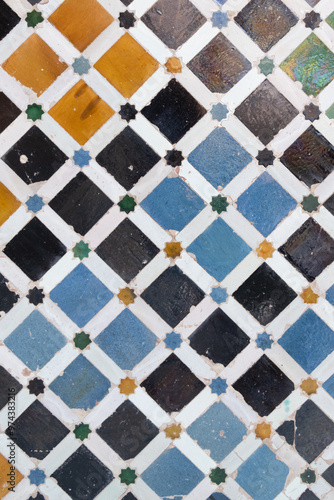 abstract colorful ancient tiles background on wall from Alhambra Castle in Granada, Spain photo