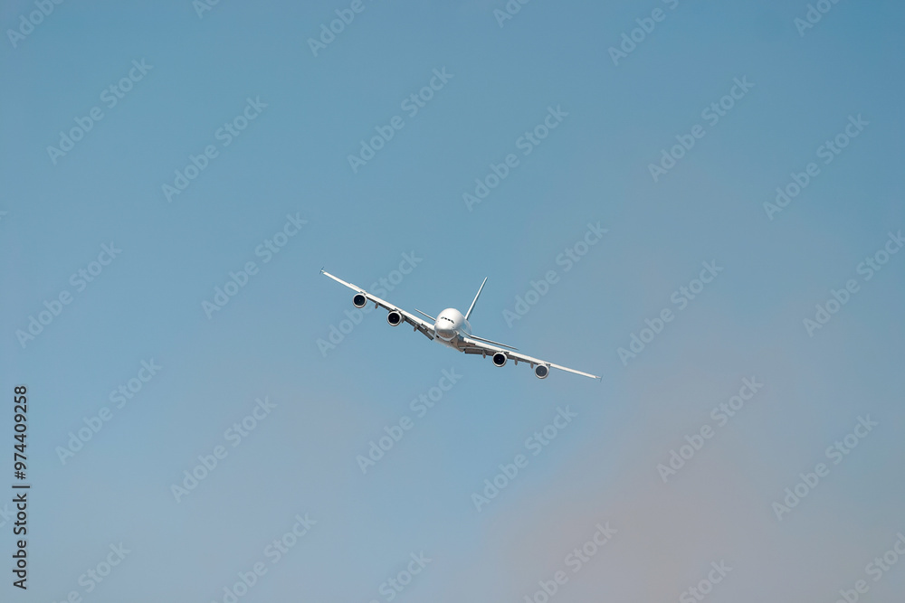 Large passenger plane is flying high in the sky, leaving a trail of white smoke behind it. The plane is tilted slightly, giving a sense of movement and altitude Large passenger plane is flying high in the sky, leaving a trail of white smoke behind it. The plane is tilted slightly, giving a sense of movement and altitude