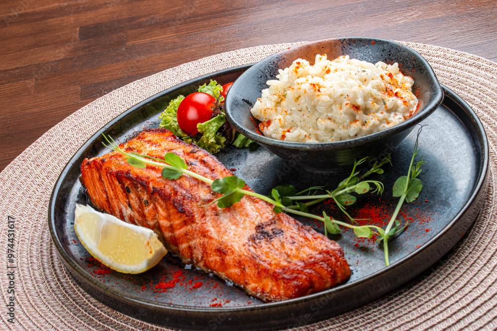 Salmon steak with creamy rice. A succulent salmon fillet, perfectly grilled or pan-seared, served alongside a bed of rich, creamy rice. Salmon steak with creamy rice. A succulent salmon fillet, perfectly grilled or pan-seared, served alongside a bed of rich, creamy rice.