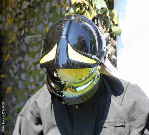 helmet of firefighters with mirrored visor lowered during national emergency photo