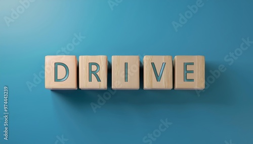 Colorful wooden blocks spell out the word 'DRIVE' against a vibrant blue background, symbolizing motivation and determination.