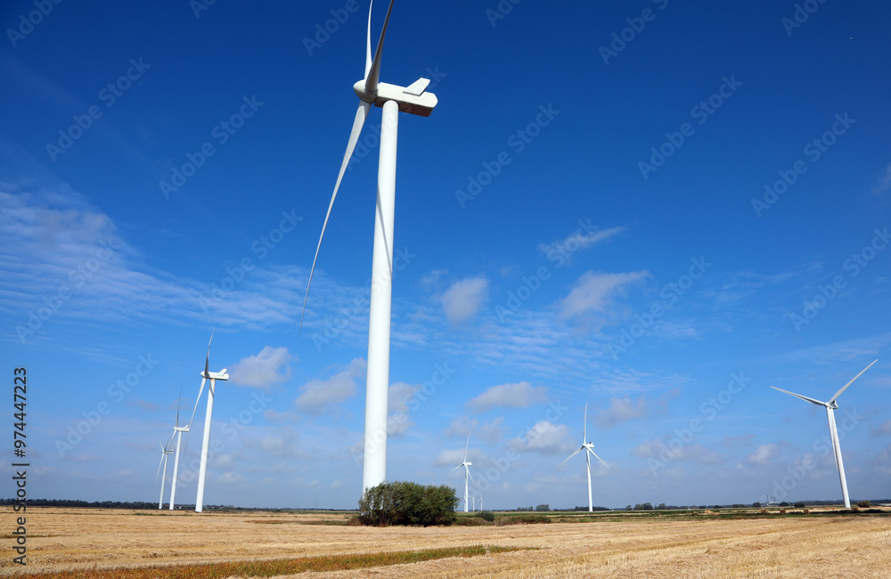 big wind turbines for the production of electricity by exploiting the force of the wind installed in an agricultural field cultivated big wind turbines for the production of electricity by exploiting the force of the wind installed in an agricultural field cultivated