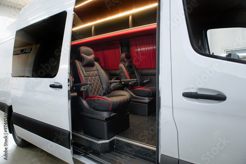 Comfortable interior of a passenger bus with soft seats. The design is made to order. Private covering of cars. Various elements of the bus interior.