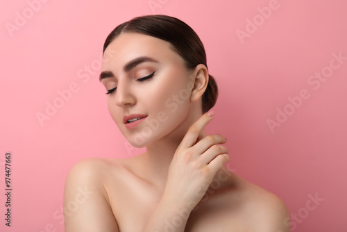 Gorgeous woman with perfect skin on pink background photo