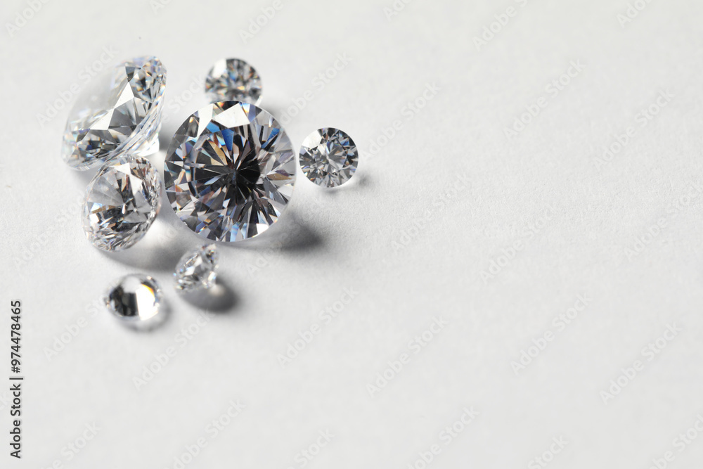 Many beautiful shiny diamonds on white background. Space for text Many beautiful shiny diamonds on white background. Space for text