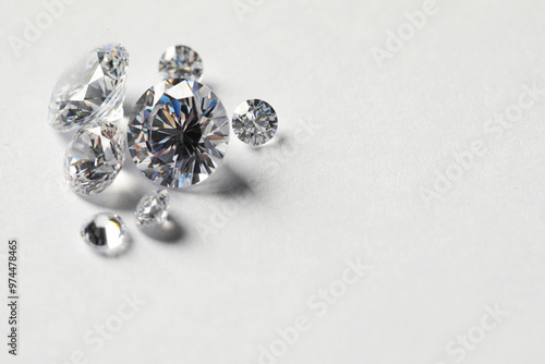 Many beautiful shiny diamonds on white background. Space for text