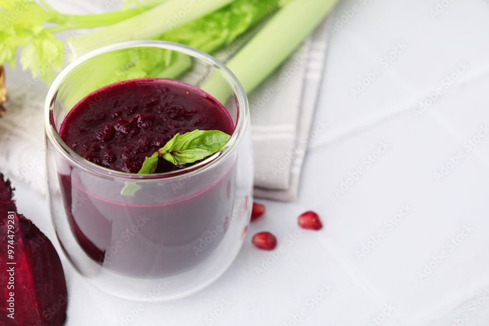 Fresh beetroot smoothie with mint in glass on white tiled table. Space for text Fresh beetroot smoothie with mint in glass on white tiled table. Space for text