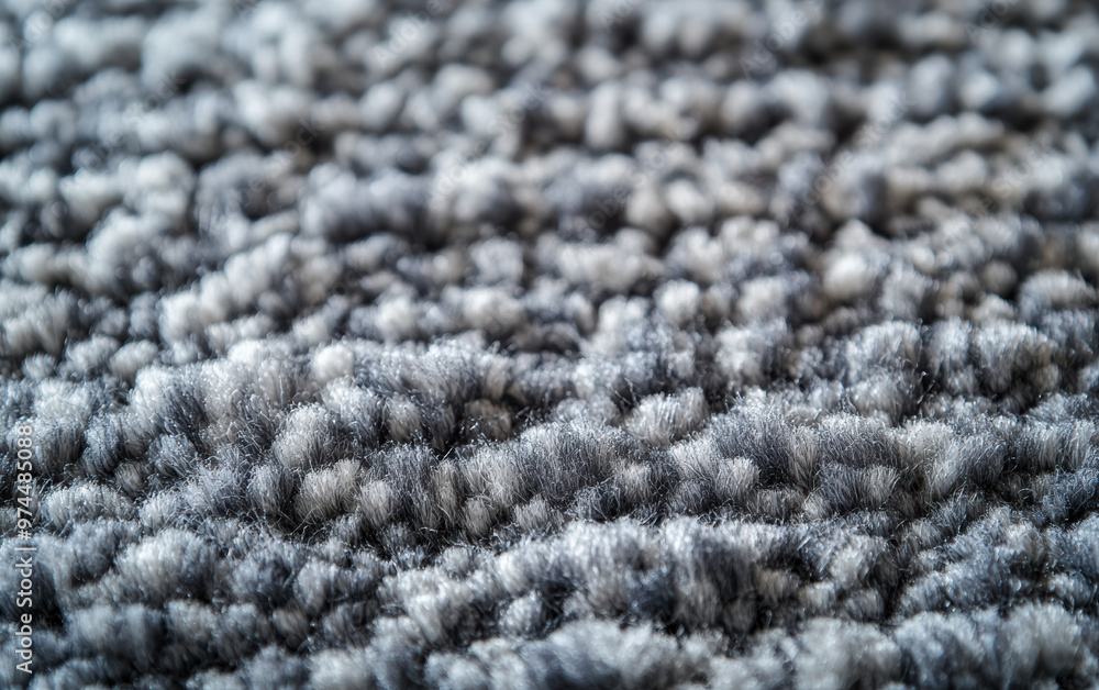 Close-up view of textured gray carpet fibers, showcasing the intricate weave pattern and soft material suitable for home decor and flooring ideas. Close-up view of textured gray carpet fibers, showcasing the intricate weave pattern and soft material suitable for home decor and flooring ideas.