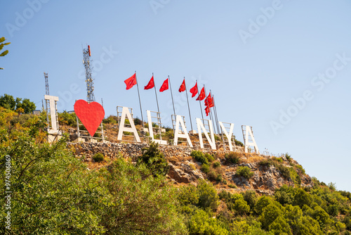 Obraz na płótnie I Love Alanya Sign With Turkish Flags and Blue Sky against clear blue sky w salonie
