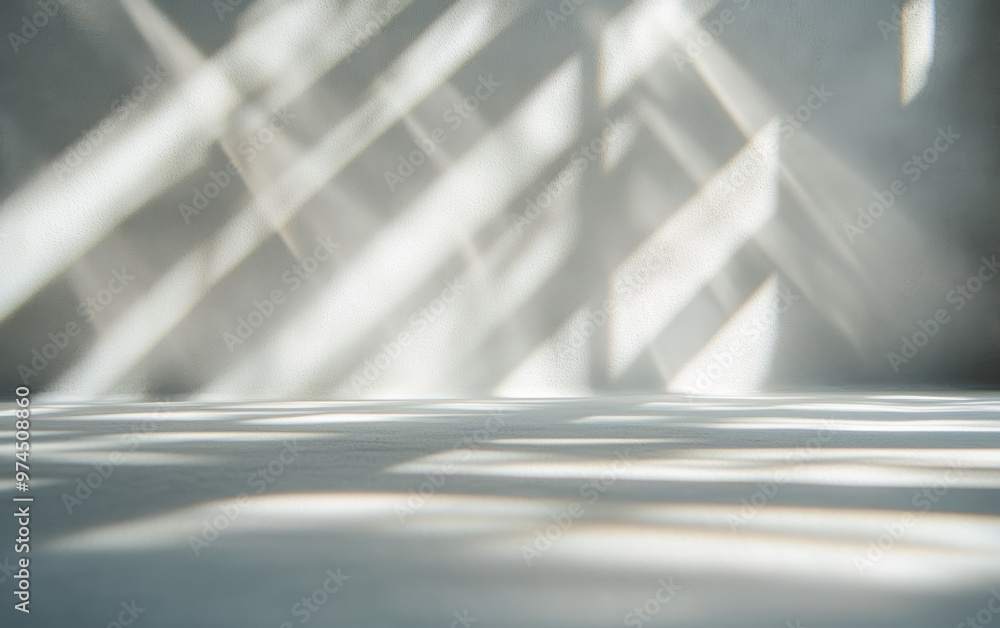 Abstract light and shadow patterns on a white wall creating a minimalist and tranquil atmosphere. Abstract light and shadow patterns on a white wall creating a minimalist and tranquil atmosphere.