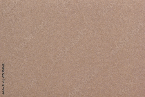 Textured glossy brown paperboard background. Horizontal scabrous cardboard background for design