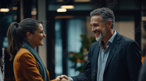 young businesspeople shake hands warmly, sealing a successful business deal during a networking event. The atmosphere is professional.