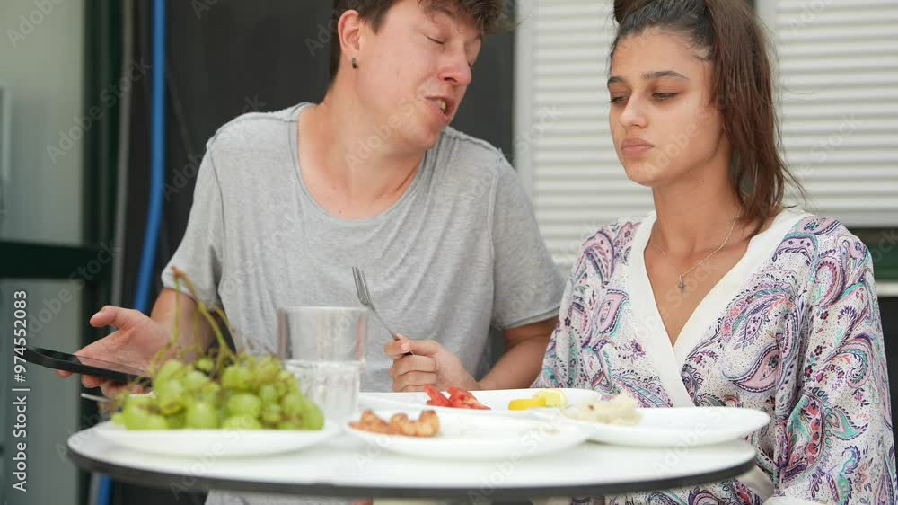 Having a delightful and fun casual breakfast chat outdoors on a beautiful, sunny day Having a delightful and fun casual breakfast chat outdoors on a beautiful, sunny day