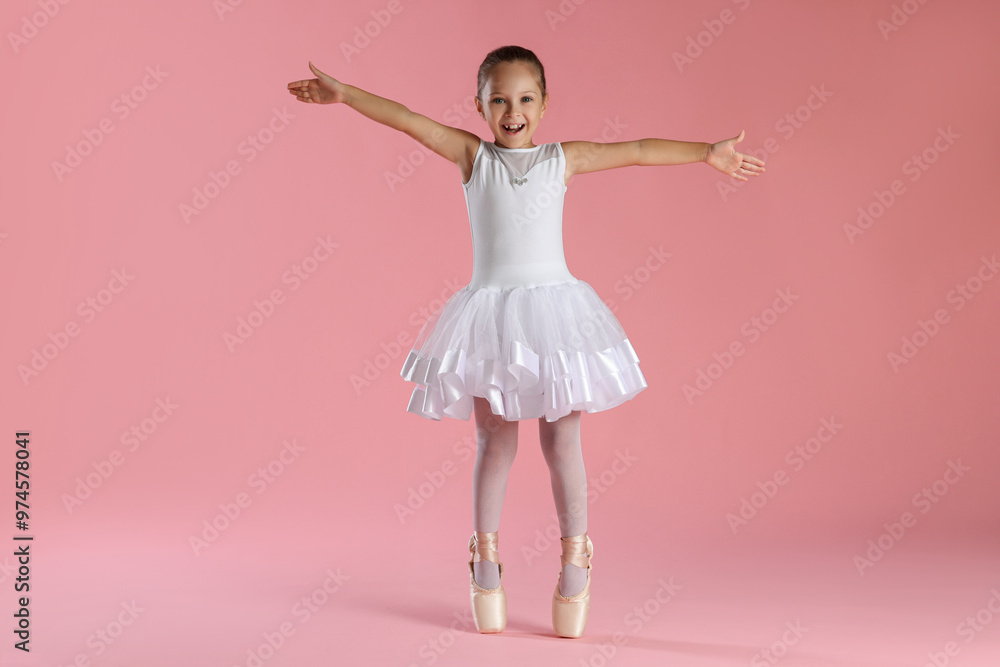 Naklejka premium Little ballerina practicing dance moves on pink background