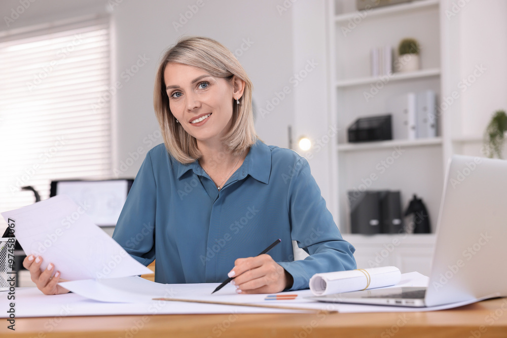 Architect making engineering drawing at table in office Architect making engineering drawing at table in office