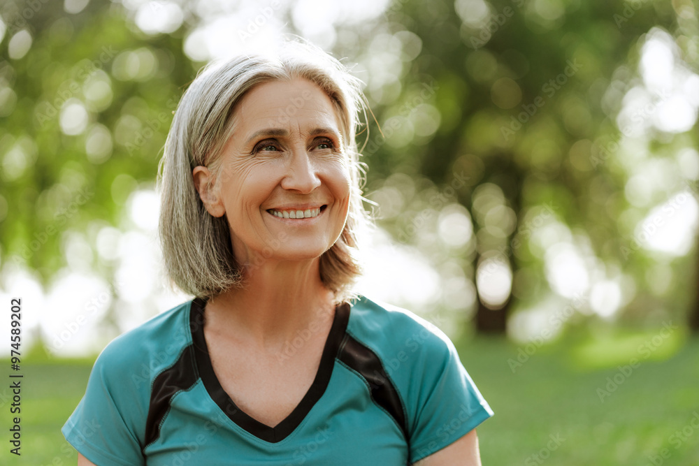 Happy senior woman smiling while enjoying nature in park, looking away, copy space Happy senior woman smiling while enjoying nature in park, looking away, copy space