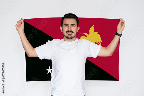 Moustached man holding Papua New Guinea flag, independence or celebration day idea, protest or  photo