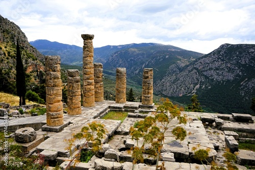 Ruins of the ancient Temple of Apollo in Delphi with its mighty round columns in Greece, overlooking the valley of Phocis on a sunny day in summer photo