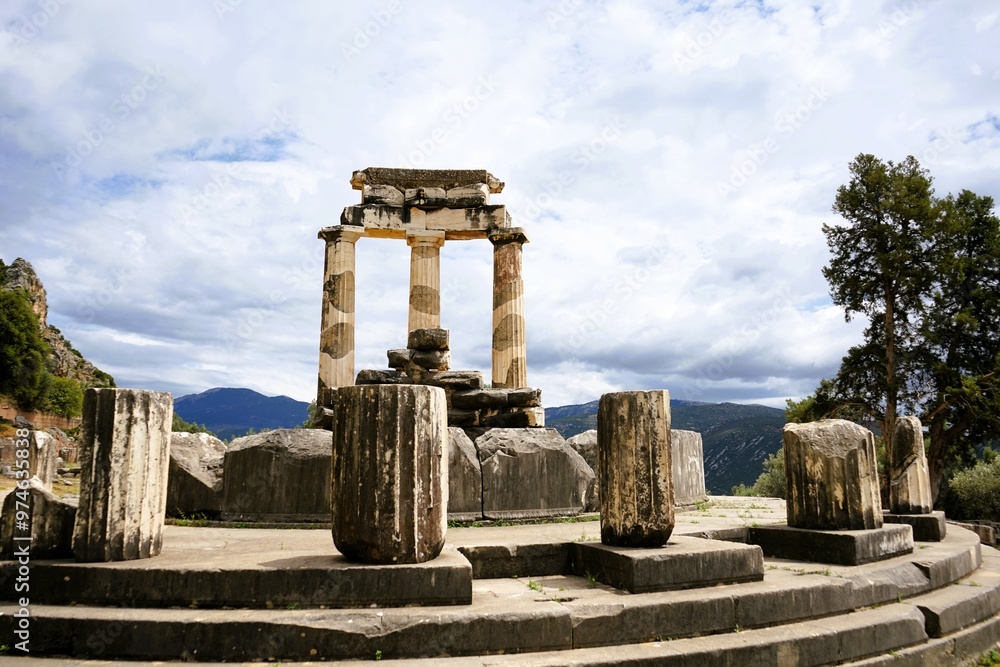 Fototapeta premium Stone remains of a tholos, a sacred circular building with columns in the sanctuary of Athena Pronaia in Delphi in Greece