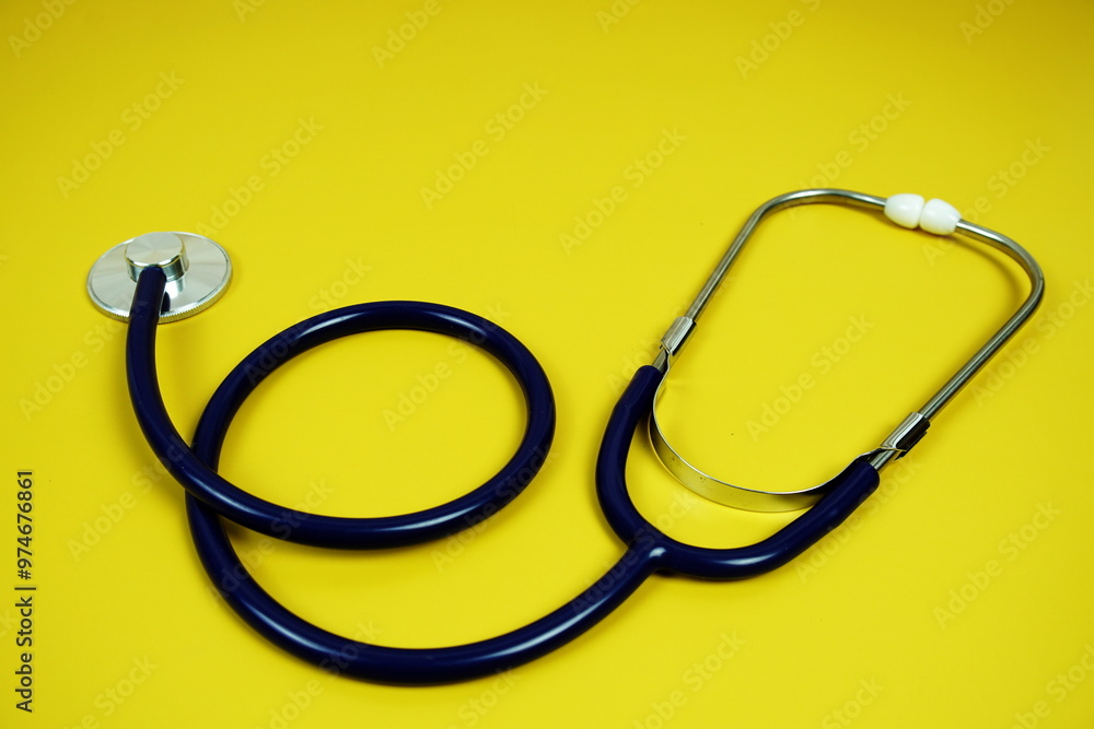 Stethoscope medical equipment isolated on yellow background Stethoscope medical equipment isolated on yellow background