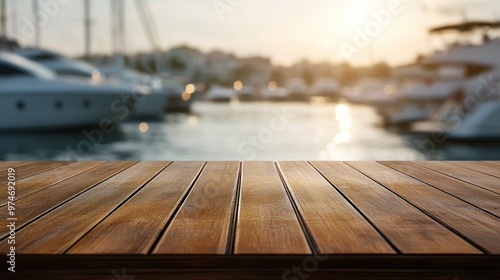 A wooden table in the foreground with a blurred marina and boats in the background at sunset.