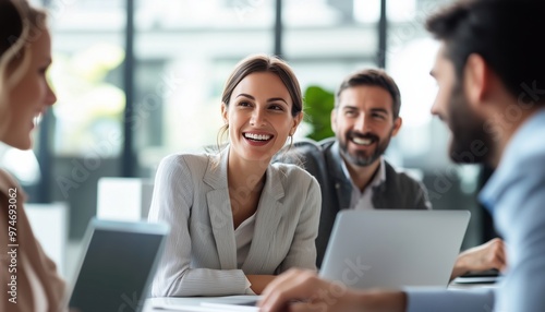 Happy Businesspeople Collaborating On A New Project In A Modern Office Environment, Using A Laptop For Teamwork. Smiles All Around!