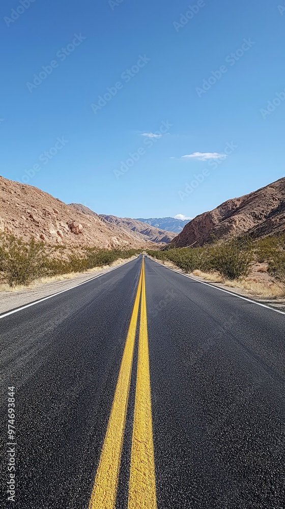 A Straight Road Through the Desert, Leading to a Mountain Range in the Distance. The Blue Sky Above is Clear and Serene. A Straight Road Through the Desert, Leading to a Mountain Range in the Distance. The Blue Sky Above is Clear and Serene.