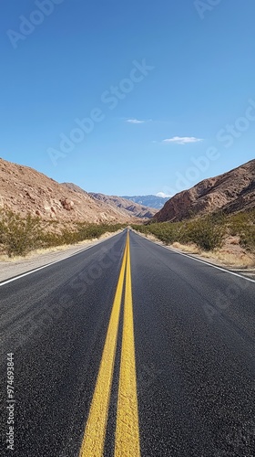 A Straight Road Through the Desert, Leading to a Mountain Range in the Distance. The Blue Sky Above is Clear and Serene.