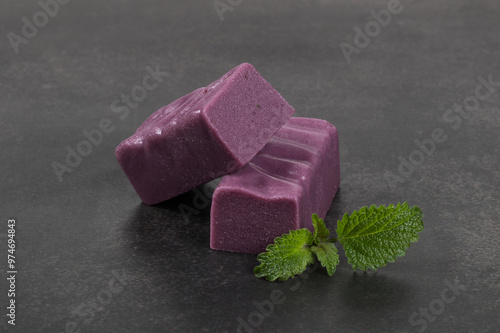 Black grape nougat. White background. Close-up