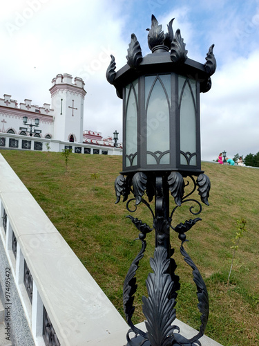 Beautiful antique lantern in forged decoration on the railing of the palace photo